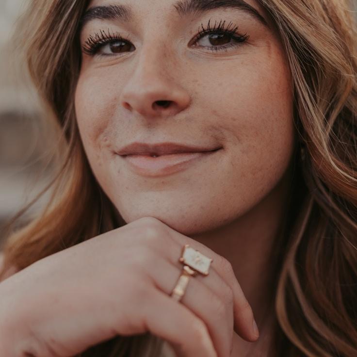 Ari Collins, Lead Design Curator at Pocket Grove Canon, reviewing corporate floral arrangements